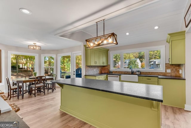 kitchen with light hardwood / wood-style flooring, green cabinets, and plenty of natural light