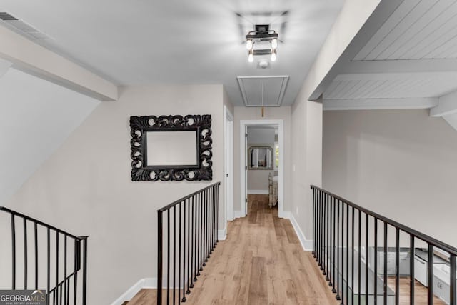 corridor with lofted ceiling with beams and light wood-type flooring