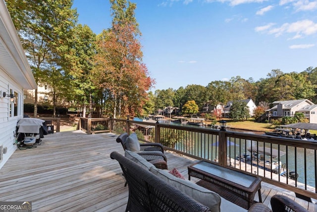 deck featuring a water view and grilling area