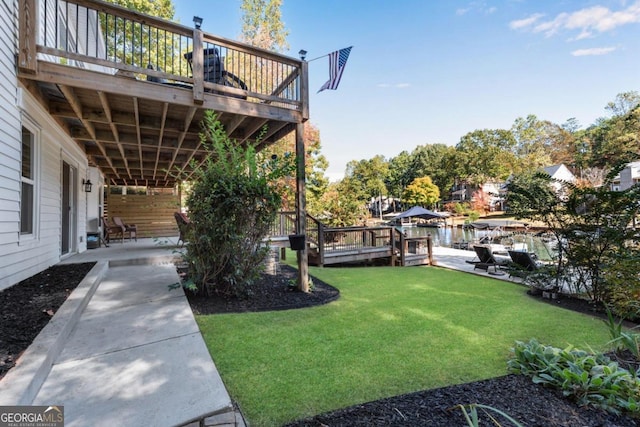 view of yard featuring a deck with water view