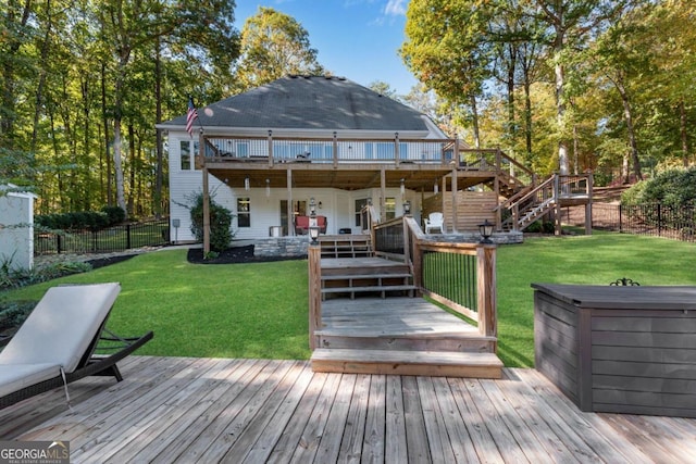 rear view of house featuring a deck and a lawn