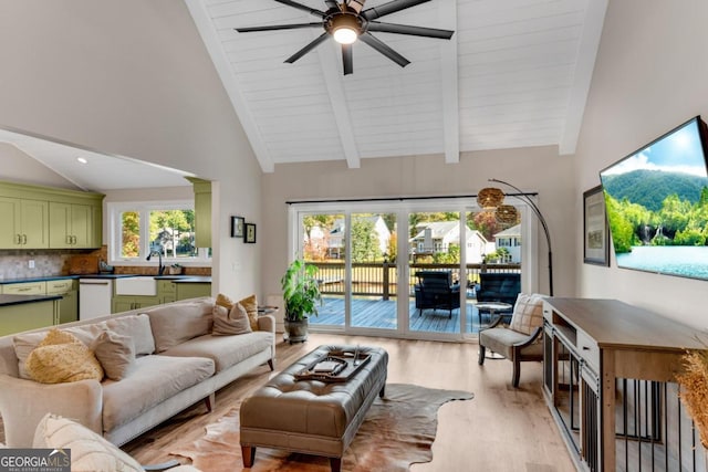 living room featuring light hardwood / wood-style floors, high vaulted ceiling, plenty of natural light, and ceiling fan