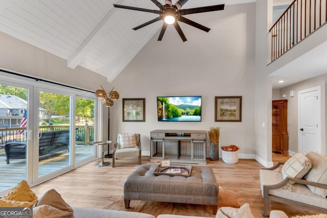 living room with beam ceiling, wooden ceiling, light wood-type flooring, high vaulted ceiling, and ceiling fan