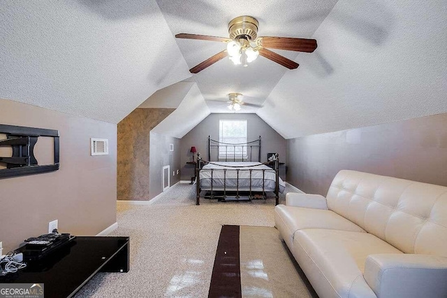 bedroom featuring lofted ceiling, a textured ceiling, carpet floors, and ceiling fan