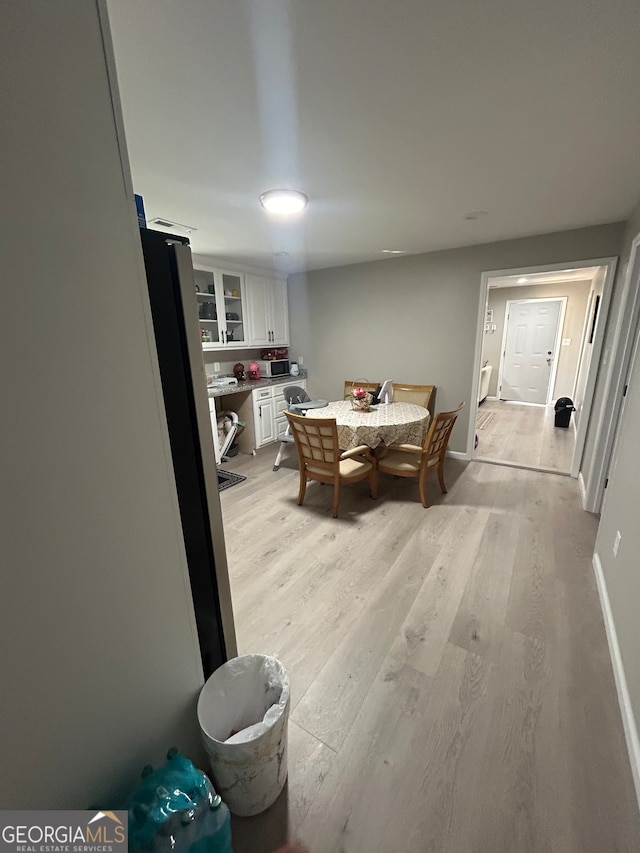 dining area featuring light wood-type flooring