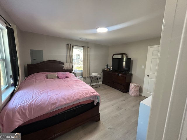 bedroom featuring light hardwood / wood-style floors and electric panel