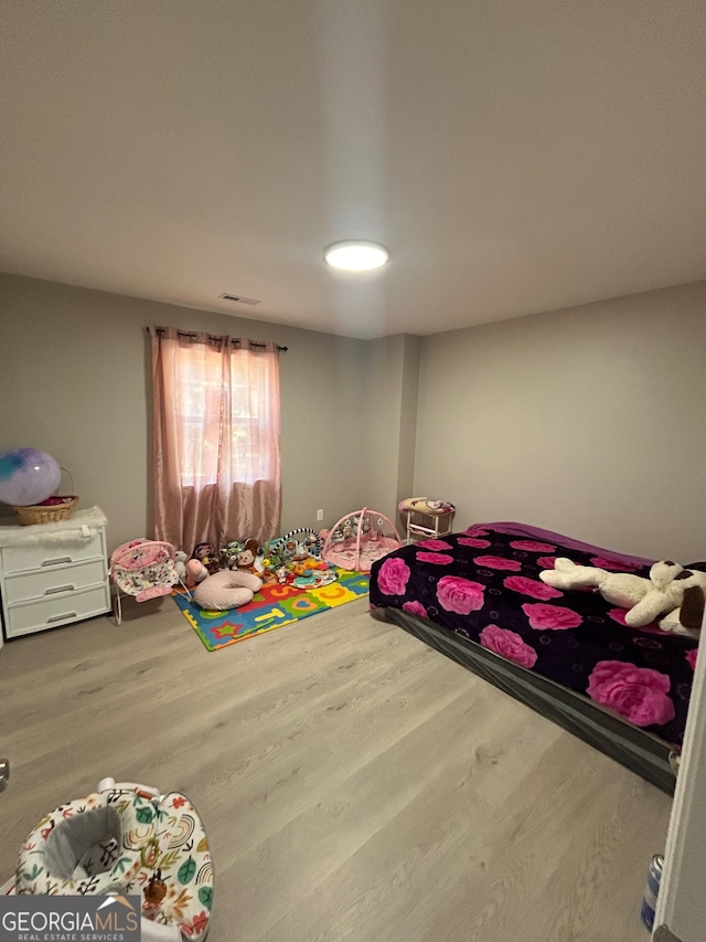 bedroom with wood-type flooring