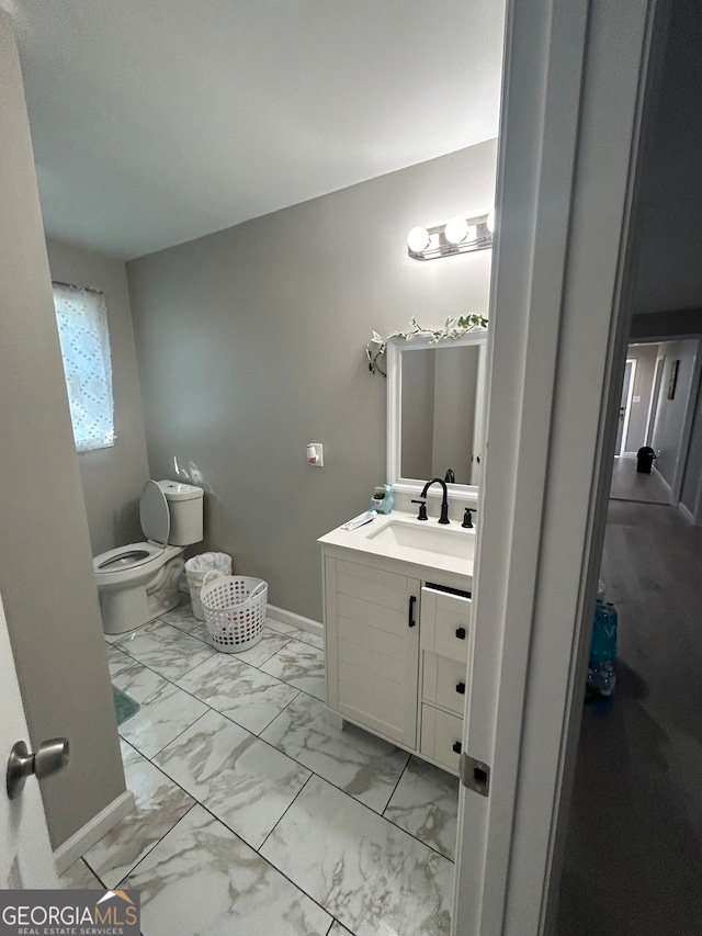 bathroom featuring vanity and toilet