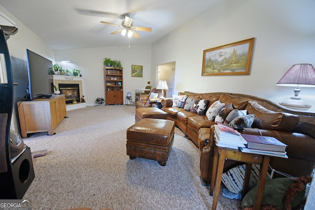 carpeted living room with ceiling fan and lofted ceiling