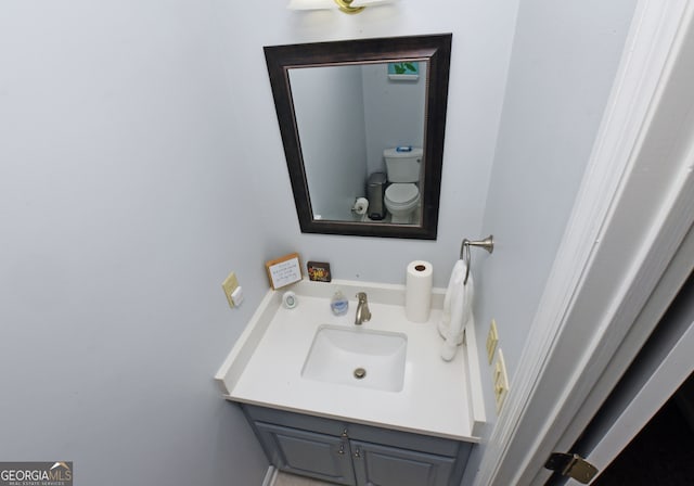 bathroom featuring vanity and toilet