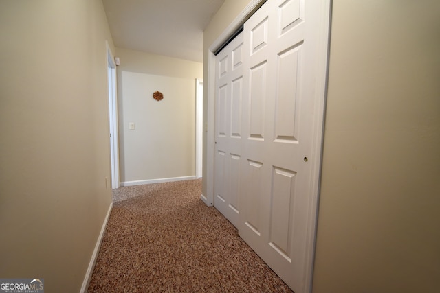 hall featuring carpet flooring