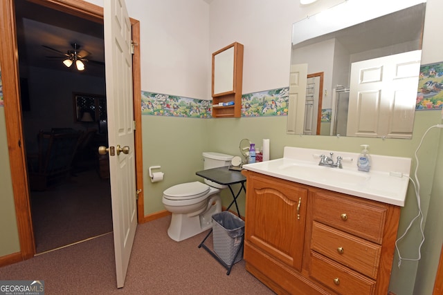 bathroom with toilet, vanity, and ceiling fan