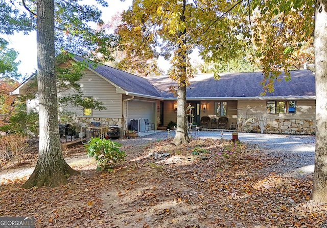 rear view of house featuring a patio area and a garage