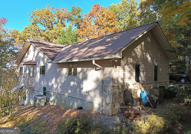 view of side of property featuring central air condition unit