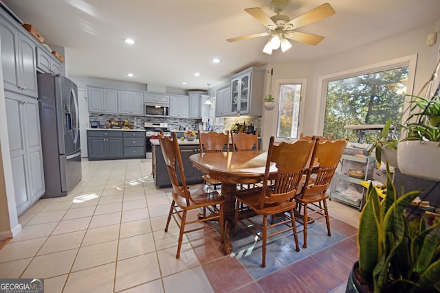 tiled dining area with ceiling fan