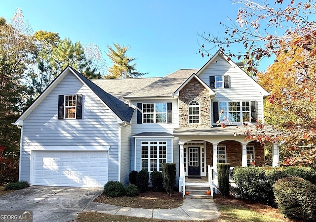 view of front of home with covered porch and a garage