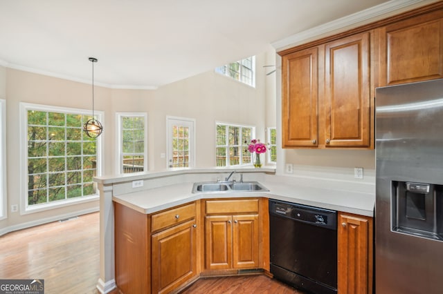 kitchen with black dishwasher, stainless steel fridge with ice dispenser, pendant lighting, light hardwood / wood-style floors, and sink