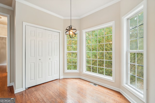 unfurnished dining area with light hardwood / wood-style floors and a healthy amount of sunlight