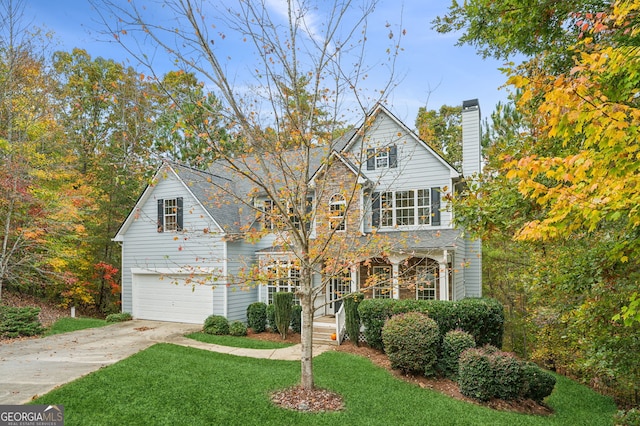 view of front of home featuring a front yard and a garage