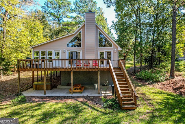 back of house with a patio area, a deck, and a lawn