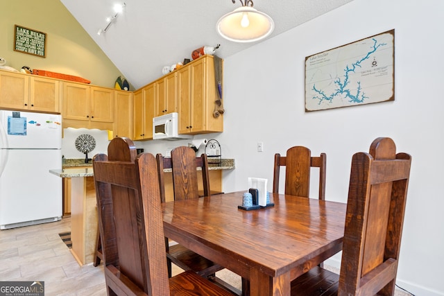 dining area with vaulted ceiling