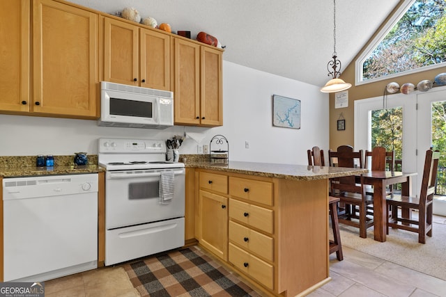 kitchen with white appliances, kitchen peninsula, vaulted ceiling, hanging light fixtures, and light tile patterned floors