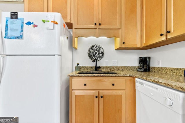 kitchen featuring white appliances and light stone countertops