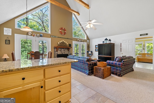 kitchen featuring high vaulted ceiling, a fireplace, ceiling fan, and light tile patterned floors