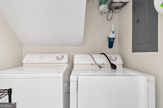 laundry room with electric panel, a textured ceiling, and independent washer and dryer