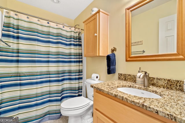 bathroom featuring toilet, vanity, a textured ceiling, and a shower with curtain