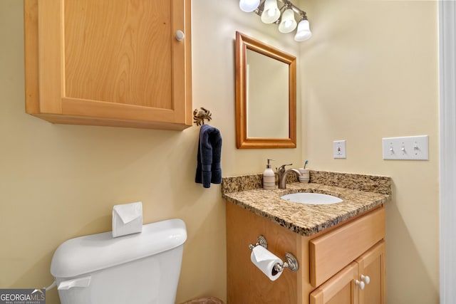 bathroom featuring toilet and vanity