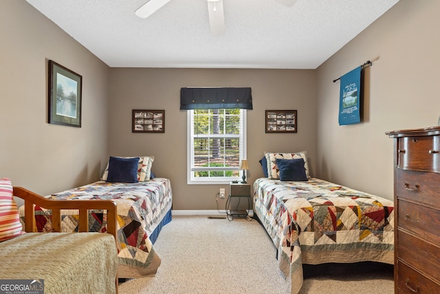 bedroom featuring a textured ceiling, ceiling fan, and light carpet