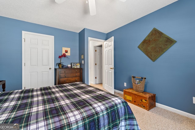 bedroom with a textured ceiling, ceiling fan, and carpet