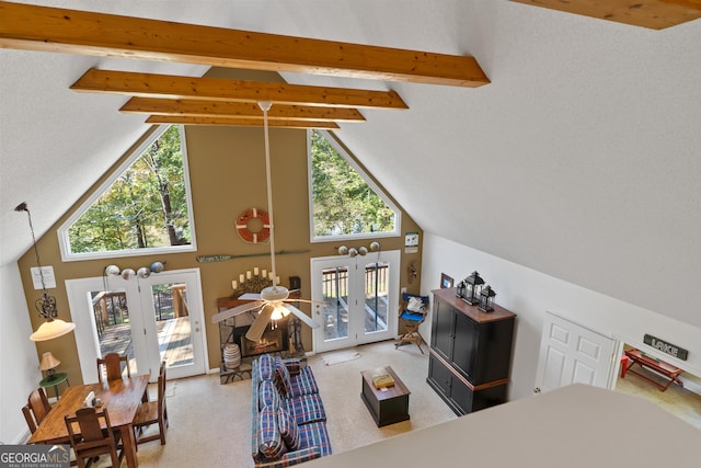 carpeted living room with high vaulted ceiling, ceiling fan, french doors, and beamed ceiling