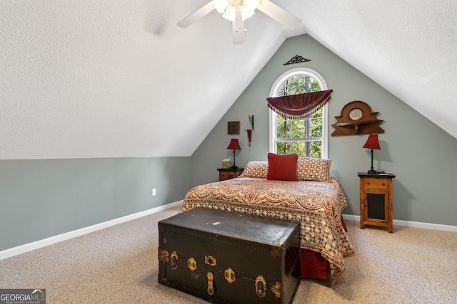 carpeted bedroom with a textured ceiling, ceiling fan, and vaulted ceiling