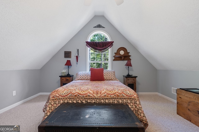 bedroom with vaulted ceiling, ceiling fan, and carpet