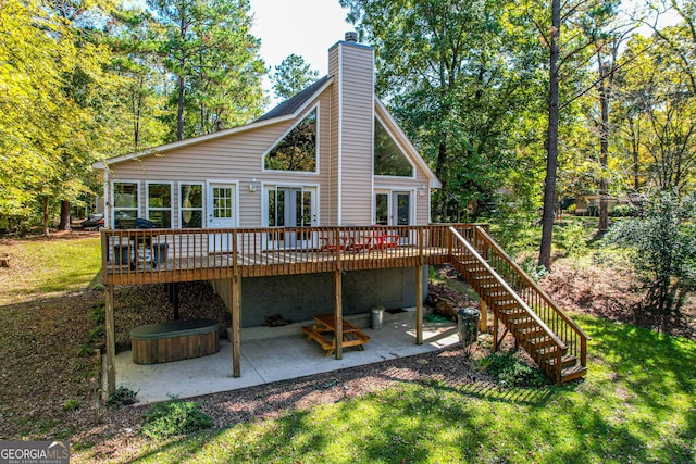 back of house with a patio area, french doors, a yard, and a deck