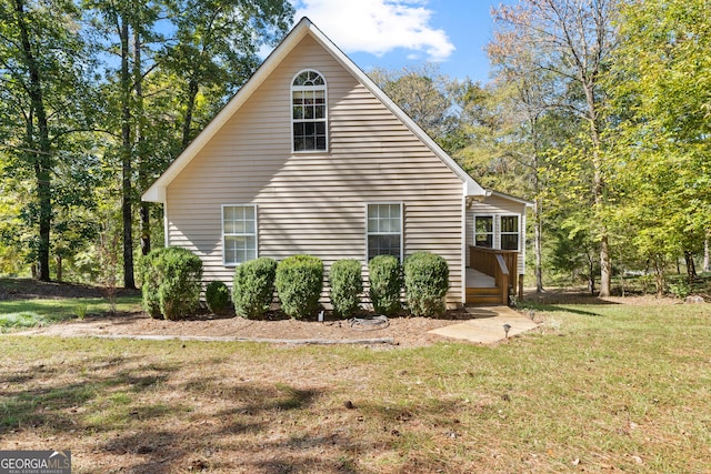 view of side of property with a lawn