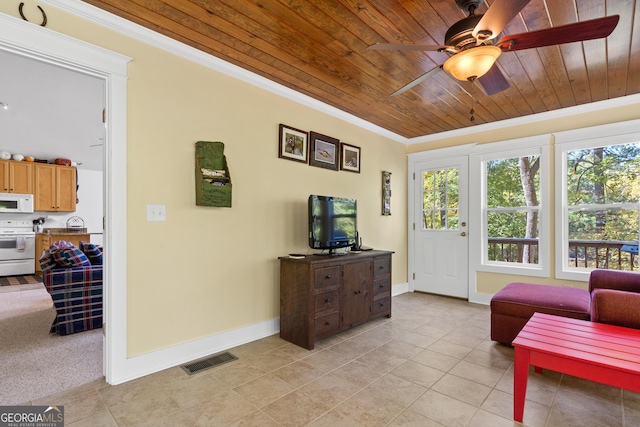 sitting room featuring ceiling fan, crown molding, light tile patterned floors, and wood ceiling