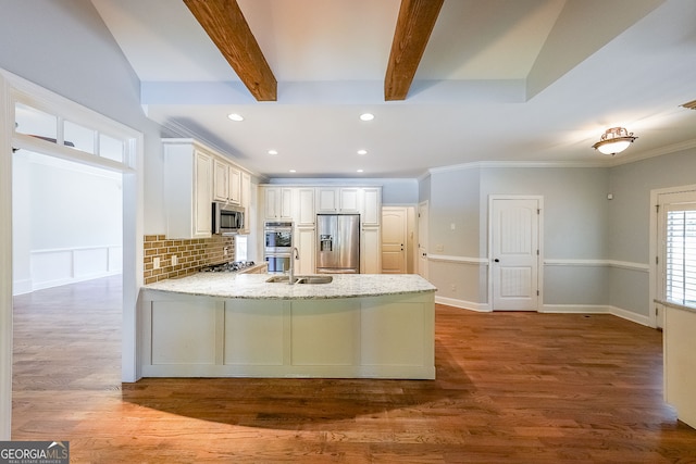 kitchen featuring wood-type flooring, kitchen peninsula, backsplash, and appliances with stainless steel finishes