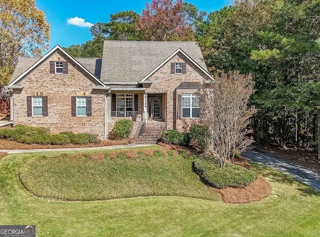 view of front of house featuring a porch and a front yard