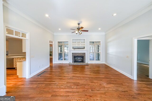 unfurnished living room with ceiling fan, crown molding, and light hardwood / wood-style flooring