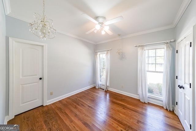 spare room featuring hardwood / wood-style flooring, plenty of natural light, and crown molding