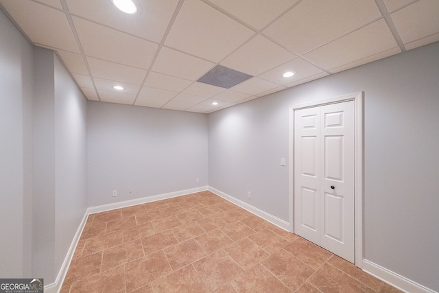 basement with a paneled ceiling