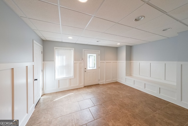 tiled foyer entrance with a drop ceiling