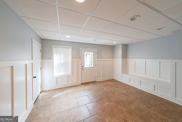 tiled foyer entrance featuring a paneled ceiling