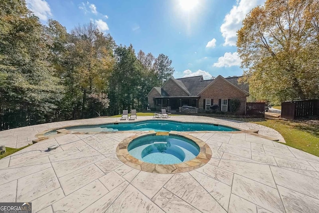 view of pool featuring an in ground hot tub and a patio area