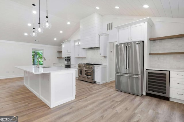 kitchen with open shelves, a sink, premium appliances, beverage cooler, and visible vents