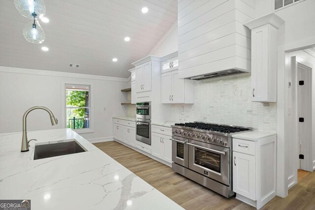 kitchen featuring white cabinetry, open shelves, a sink, stainless steel appliances, and custom exhaust hood