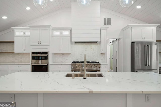 kitchen with decorative backsplash, high quality appliances, vaulted ceiling, white cabinetry, and visible vents